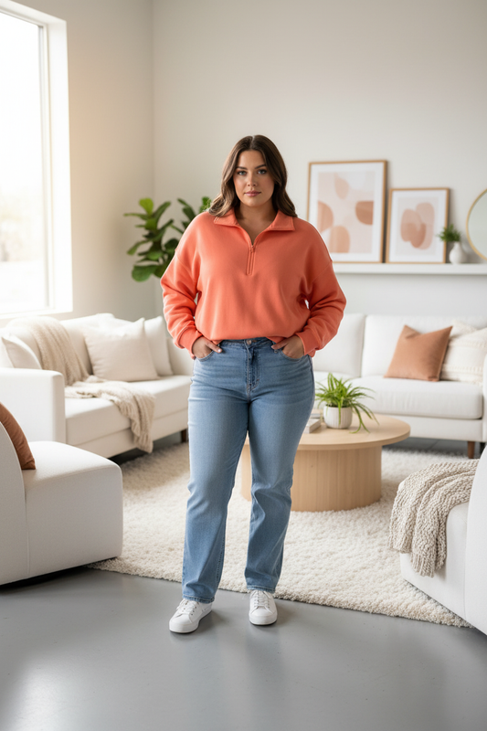 Coral hoodie on curvy model in white living room